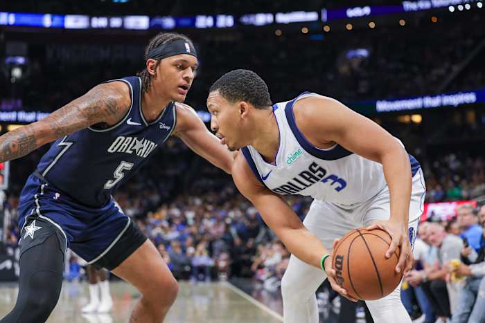 Orlando Magic forward Paolo Banchero defending Dallas Mavericks forward Grant Williams.